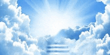 the sun is shining through the clouds and a staircase is leading to heaven .