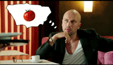 a man sitting at a table with a cup of coffee and a tomato in a thought bubble