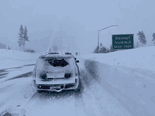 a snowy road with a sign that says donner summit on it