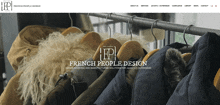 a website for french people design shows a row of jackets hanging on a rack