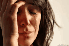 a woman crying with a tear coming out of her eye