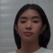 a close up of a woman 's face with a blurred background .