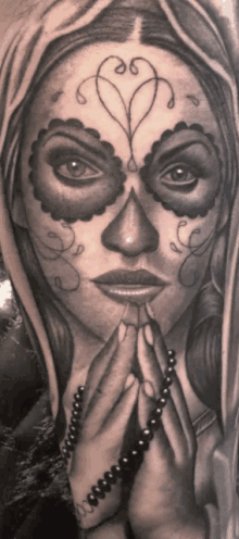 a black and white drawing of a woman with a sugar skull face