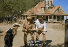 a group of men are standing in front of a house holding guns and saying hey you in the crate