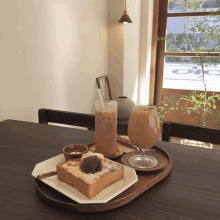 a tray of food and drinks on a table with a glass of iced coffee