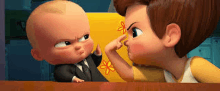 a baby in a suit and tie is standing next to a boy in a yellow tank top .