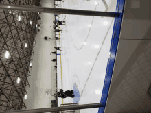 a hockey game is being played in a stadium with a sign on the wall that says ice hockey