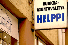 a helppi sign hangs outside a building