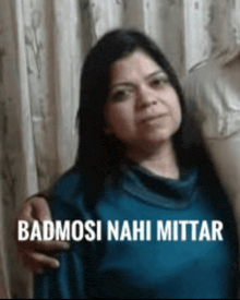 a woman in a blue shirt with the words badmosi nahi mittar