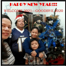 a family posing for a picture in front of a christmas tree