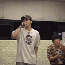 a man is singing into a microphone in a room