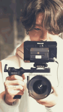 a person is holding a camera that says edu on the front