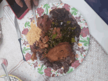 a plate of food with a knife and fork on a table next to a cell phone