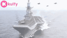 a large military ship is floating on top of a body of water ..