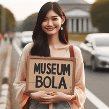 a woman holds up a sign that says museum bola