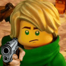 a close up of a lego character holding a gun .