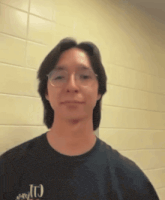 a man wearing glasses and a t-shirt that says j.r.g.t.