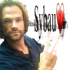 a man is standing in front of a sign that says sybau on it