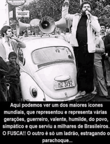 a black and white photo of a man standing in front of a car with a license plate that says mz 8192