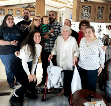 a group of people posing for a picture including an older woman