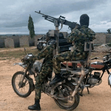 two soldiers are riding motorcycles with a machine gun on top