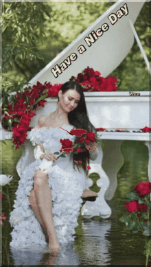 a woman in a white dress sits on a piano surrounded by red roses with the words have a nice day above her