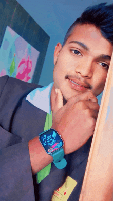 a young man wearing a smart watch that says ' 10:09 ' on it