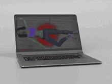 a laptop screen shows a woman doing exercises with green arms and legs