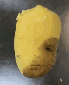 a potato that looks like a face is sitting on a table