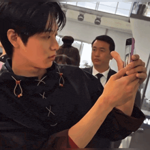 a man is taking a picture of himself with his cell phone