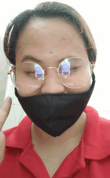 a woman wearing glasses and a mask has a picture of a man in her eyes