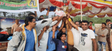 a group of men are holding up a trophy in front of a banner that says limited-damant