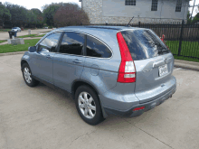 a honda crv is parked in a driveway with a texas license plate