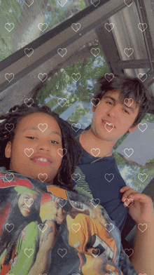 a boy and a girl are posing for a picture with hearts on them