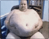 a man with a very large belly is sitting in a chair in front of a bookshelf