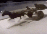 a black and white photo of a horse pulling a cart