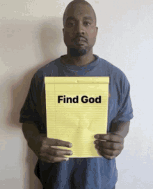 a man is holding a piece of paper that says find god on it