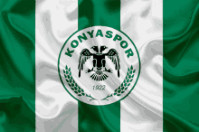 a green and white flag with the word konyaspor in the middle