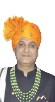 a man wearing an orange turban and green beads