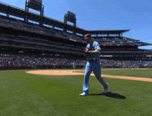 a baseball player wearing a blue uniform with the word denver on it