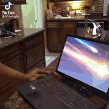 a tiktok video of a person using a laptop with a shooting star on the screen