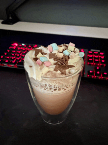 a glass of hot chocolate with whipped cream and marshmallows on top