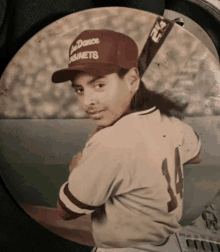 a young boy wearing a baseball cap that says sea dance cabinets