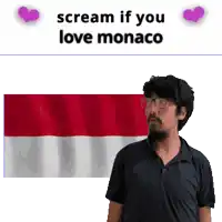 a man with glasses and a beard stands in front of a flag that says " scream if you love monaco "