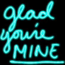 neon sign that says glad you 're mine on a black background