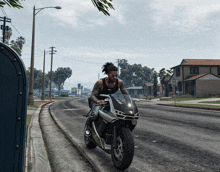 a man is riding a motorcycle down a street that has a no parking sign