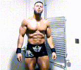 a shirtless wrestler is standing in front of a radiator