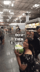 a woman holding a watermelon in a grocery store with the words do u even lift bro written on it