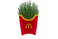 a mcdonald 's french fries container with green grass inside