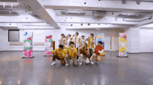 a group of young men are posing for a picture in a room with a sign that says love on it